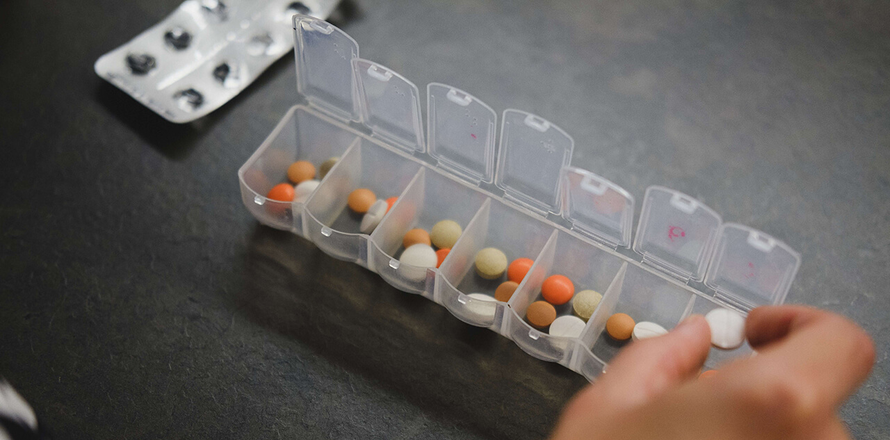Pills in daily dosage tray, biotin dosage